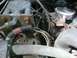 1989 Ford Bronco - Close-up view of an engine bay, showing various hoses and electrical wiring.
