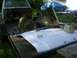 1989 Ford Bronco - Trailer loaded with truck parts and a disassembled chassis, outdoors.