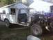 1989 Ford Bronco - This white pickup truck is missing its front end, revealing the engine compartment and various hoses.
