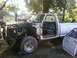 1989 Ford Bronco - White pickup truck in a yard, appearing to be undergoing repairs or disassembly.
