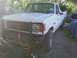 1989 Ford Bronco - This white Ford F-250 truck is parked outdoors with a brush guard and a large aftermarket bumper. A second vehicle is visible in the backgr…