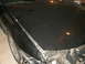 1998 Lincoln Mark VIII - Front view of a black car's damaged hood and fender, showing significant wear and tear.