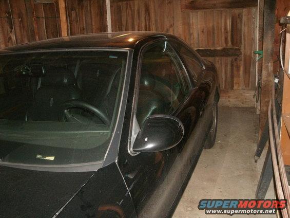 black 1998 Lincoln Mark VIII parked inside a wooden garage