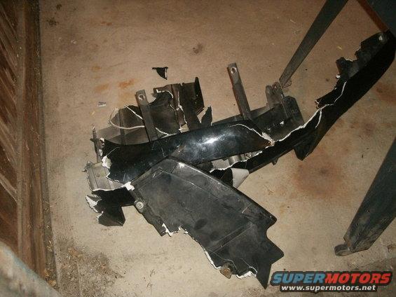 Broken black car bumper on concrete floor