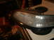 1998 Lincoln Mark VIII - A headlight assembly rests on a kitchen stovetop, with various items in the background.