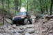 1984 Ford Bronco II - Jeep Grand Cherokee tackling a difficult off-road course with large tires and suspension modifications.