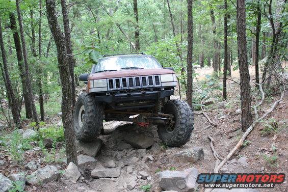 Brown Jeep Grand Cherokee ZJ on rocky trail