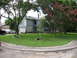 1983 Ford 427 - A suburban house with a well-manicured lawn, a white sedan and a black SUV parked in the driveway.