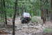 1984 Ford Bronco II - A red SUV tackles a challenging off-road course through a dense forest.