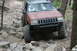 1984 Ford Bronco II - This modified Jeep navigates a challenging rocky terrain, its off-road capabilities.