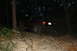 1984 Ford Bronco II - SUV navigating a steep, rocky incline in a wooded area after dark.