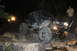 1984 Ford Bronco II - A modified off-road vehicle navigates a rocky terrain under artificial lighting at night.