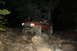 1984 Ford Bronco II - A driver navigates a rocky trail in a modified Jeep Cherokee XJ after dark.