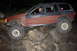 1984 Ford Bronco II - A modified Jeep Grand Cherokee navigates a rocky trail at night.