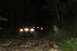 1984 Ford Bronco II - Outdoor scene at night with indistinct lights, possibly from a building or vehicles.