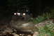 1984 Ford Bronco II - A vehicle navigates a rough, unlit path in the dark, illuminated only by its headlights.