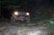 1984 Ford Bronco II - An SUV is seen from the front at night, its headlights illuminating the road ahead.
