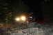 1984 Ford Bronco II - Headlights of an unidentified vehicle are visible in the darkness.