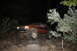 1984 Ford Bronco II - Red SUV parked outside at night, with trees visible in the foreground.