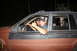 1984 Ford Bronco II - Two men are inside a 1984 Ford Bronco II, with one giving a thumbs-up.