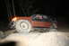 1984 Ford Bronco II - This modified SUV is navigating a rocky trail in the dark, with a person visible in the driver's seat.