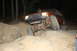 1984 Ford Bronco II - An off-road SUV navigates a rocky trail in the dark.