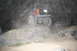 1984 Ford Bronco II - SUV navigating difficult terrain on rocks at night.