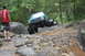 1984 Ford Bronco II - Modified Jeep Cherokee XJ navigating a difficult rocky trail with a second Jeep following.