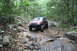 1984 Ford Bronco II - This lifted Jeep Grand Cherokee tackles a challenging rocky stream during an off-road adventure.
