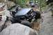 1984 Ford Bronco II - Off-road vehicle tackles challenging rocky trail with spectators watching.