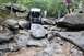 1984 Ford Bronco II - Custom off-road buggy navigates a challenging rocky terrain with spectators observing.
