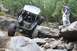 1984 Ford Bronco II - Two men observe a custom off-road buggy navigating a rocky trail.