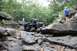 1984 Ford Bronco II - An off-road buggy tackles a challenging rocky terrain with spectators observing the action.