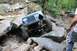 1984 Ford Bronco II - A blue Jeep navigates a challenging rocky terrain during an off-road excursion.