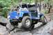 1984 Ford Bronco II - This blue off-road vehicle is shown navigating a rocky terrain, demonstrating its off-road capabilities.