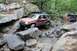 1984 Ford Bronco II - Off-roading through a challenging rocky terrain with multiple vehicles.