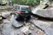 1984 Ford Bronco II - Jeep Grand Cherokee tackling a difficult off-road obstacle on a rocky trail.