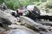 1984 Ford Bronco II - A Jeep Grand Cherokee tackles a challenging rocky obstacle course.