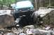 1984 Ford Bronco II - Jeep Cherokee XJ tackling a difficult rocky off-road course with another vehicle following.
