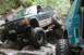 1984 Ford Bronco II - This dark blue SUV, possibly a 1990 Ford Explorer, is shown tackling a challenging rocky trail with another vehicle visible.