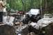 1984 Ford Bronco II - Two off-road vehicles, a 1984 Ford Bronco II and a red Jeep Wrangler, navigate a challenging rocky trail.