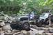 1984 Ford Bronco II - Modified Jeeps tackling a challenging rocky off-road course.