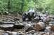 1984 Ford Bronco II - This off-road vehicle is navigating a challenging rocky path, with another vehicle following behind.