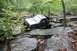 1984 Ford Bronco II - An off-road SUV navigates a challenging rocky path, with another vehicle following in the distance.