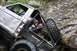 1984 Ford Bronco II - This heavily modified off-road vehicle is navigating a challenging rocky terrain.
