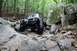 1984 Ford Bronco II - This heavily modified SUV navigates a challenging rocky terrain, its off-road capabilities.