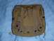 1991 Ford Bronco - This is a close-up view of the back of a tan tactical pouch, showing its attachment straps and buckle.