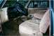 1990 Ford Bronco - The interior of this vehicle features tan cloth seats and a wood-grain trim on the dashboard.