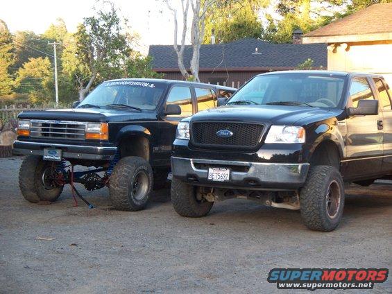 Black Ford F-150 with lifted suspension and aftermarket grille