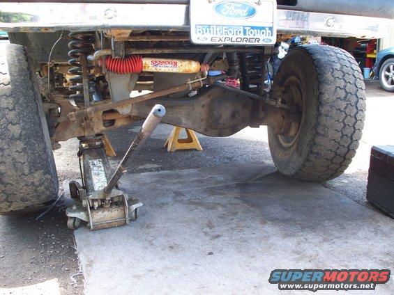 1977 Ford F-150 rear axle assembly supported by a floor jack and jack stands